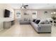 Living room with large sectional couch, TV, and view of the dining area at 3935 Nw 46Th Ter, Ocala, FL 34482