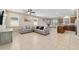 This light-filled living room offers tile flooring, neutral paint, and an open layout to the kitchen at 3935 Nw 46Th Ter, Ocala, FL 34482