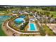 Overhead view showcasing the community pools, lush landscaping, and recreational amenities at 3935 Nw 46Th Ter, Ocala, FL 34482