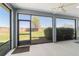 The screened porch features a ceiling fan and overlooks the backyard at 3935 Nw 46Th Ter, Ocala, FL 34482