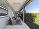 Screened patio with outdoor seating, perfect for relaxing and enjoying the views at 3935 Nw 46Th Ter, Ocala, FL 34482