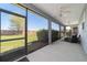 Spacious screened-in porch includes ceiling fans and backyard views at 3935 Nw 46Th Ter, Ocala, FL 34482
