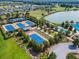 Aerial view of community tennis courts near the pool, with lush landscaping and parking available at 3935 Nw 46Th Ter, Ocala, FL 34482