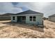 Back exterior of home featuring large windows, completed construction with tire tracks in the backyard at 4504 Sw 90Th Lane Rd, Ocala, FL 34476