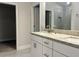 Modern bathroom with double vanity, granite countertops, and a glass-enclosed shower at 4504 Sw 90Th Lane Rd, Ocala, FL 34476