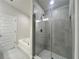 Bathroom featuring a glass shower, soaking tub, and tiled walls, offering a spa-like experience at 4504 Sw 90Th Lane Rd, Ocala, FL 34476