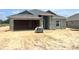 New construction home featuring concrete block exterior and an attached two-car garage in a sunny neighborhood at 4504 Sw 90Th Lane Rd, Ocala, FL 34476