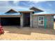 Unfinished block home featuring a two-car garage, covered entry, and white window against a blue sky at 4504 Sw 90Th Lane Rd, Ocala, FL 34476