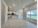 Open kitchen with granite countertops, stainless appliances, and a large window overlooking the backyard at 4504 Sw 90Th Lane Rd, Ocala, FL 34476