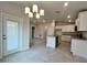 Modern kitchen with white cabinets, an island, and granite countertops offers ample counter space at 4504 Sw 90Th Lane Rd, Ocala, FL 34476