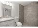 Well-lit bathroom with a modern vanity and a walk-in shower featuring decorative tile work at 4585 Se 136Th St, Summerfield, FL 34491