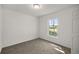 Cozy bedroom with a window providing natural light and a neutral color palette at 4585 Se 136Th St, Summerfield, FL 34491