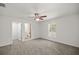 Bedroom showcasing neutral carpeting, a ceiling fan, and a view from the window at 4585 Se 136Th St, Summerfield, FL 34491