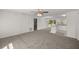 Bright and spacious living room with neutral carpet and white walls, and open to kitchen at 4585 Se 136Th St, Summerfield, FL 34491