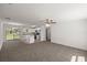 Open concept living room with new carpet and neutral paint, and an island at 4585 Se 136Th St, Summerfield, FL 34491