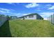 Expansive grassy backyard with privacy fence offering plenty of space for outdoor activities at 5048 Sw 57Th Pl, Ocala, FL 34474