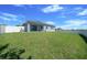 Large, grassy backyard featuring a privacy fence and covered patio at 5048 Sw 57Th Pl, Ocala, FL 34474