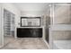 Spacious bathroom with a granite vanity, shower with glass door, and access to a custom closet at 5048 Sw 57Th Pl, Ocala, FL 34474