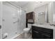 Bathroom features a granite vanity, stylish dark wood cabinets, and glass-enclosed walk-in shower at 5048 Sw 57Th Pl, Ocala, FL 34474