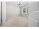Bright, carpeted bedroom with a modern chandelier and large windows at 5048 Sw 57Th Pl, Ocala, FL 34474