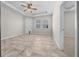 Bedroom with tiled floor, tray ceiling, ceiling fan, and natural light at 5048 Sw 57Th Pl, Ocala, FL 34474