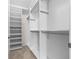 Walk-in closet featuring custom shelving, rods, and ample storage space at 5048 Sw 57Th Pl, Ocala, FL 34474