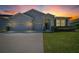 Charming single-Gathering home with a well-manicured lawn and a three-car garage at sunset at 5048 Sw 57Th Pl, Ocala, FL 34474