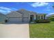 Charming single-Gathering home with a well-manicured lawn and a three-car garage on a sunny day at 5048 Sw 57Th Pl, Ocala, FL 34474