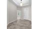 Inviting foyer with neutral-toned tile floors, white walls, and a modern light fixture at 5048 Sw 57Th Pl, Ocala, FL 34474