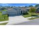 Well-manicured home exterior showcasing a three-car garage, appealing landscaping, and tasteful design at 5048 Sw 57Th Pl, Ocala, FL 34474