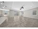 Spacious living area featuring neutral colors, tray ceiling, and sliding glass doors to the yard at 5048 Sw 57Th Pl, Ocala, FL 34474
