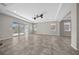 Bright, open living area with sliding glass doors, tray ceiling, and modern ceiling fans at 5048 Sw 57Th Pl, Ocala, FL 34474