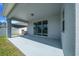Covered patio with ample space for outdoor dining or lounging next to the backyard at 5048 Sw 57Th Pl, Ocala, FL 34474