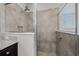This bathroom features a tiled standing shower with glass doors and granite countertops at 5048 Sw 57Th Pl, Ocala, FL 34474