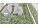 Aerial view of a well-maintained backyard with a screened-in porch, surrounded by a white picket fence at 6 Diamond Cove Ct, Ocala, FL 34472