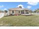 A spacious backyard with green grass and a screened-in porch offers a private outdoor living space at 6 Diamond Cove Ct, Ocala, FL 34472