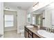 Bathroom features a double sink vanity with framed mirror, and granite countertop at 6 Diamond Cove Ct, Ocala, FL 34472