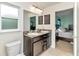 Bathroom with a double sink vanity, framed mirror and a view into the ensuite bedroom at 6 Diamond Cove Ct, Ocala, FL 34472