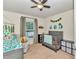 Bright bedroom featuring a ceiling fan, neutral walls, and a garden view at 6 Diamond Cove Ct, Ocala, FL 34472
