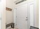 Clean, white front door with sidelights and a bench; entryway with coat rack at 6 Diamond Cove Ct, Ocala, FL 34472