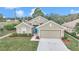Charming single-story home featuring a blue front door, manicured lawn, and a two-car garage at 6 Diamond Cove Ct, Ocala, FL 34472