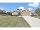 Beautiful one-story home with a two-car garage, lush lawn and a bright blue front door at 6 Diamond Cove Ct, Ocala, FL 34472