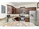 Stylish kitchen with stainless steel appliances, granite countertops, and dark wood cabinets at 6 Diamond Cove Ct, Ocala, FL 34472
