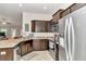 Well-equipped kitchen featuring stainless steel appliances and dark cabinets at 6 Diamond Cove Ct, Ocala, FL 34472