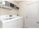 Convenient laundry room equipped with a washer, dryer, and extra storage at 6 Diamond Cove Ct, Ocala, FL 34472