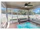 Enclosed porch with ceiling fan, furniture and view of fenced backyard at 6 Diamond Cove Ct, Ocala, FL 34472