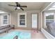 Enclosed porch with ceiling fan, furniture and view of fenced backyard at 6 Diamond Cove Ct, Ocala, FL 34472