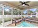 Enclosed porch with ceiling fan, furniture and view of fenced backyard at 6 Diamond Cove Ct, Ocala, FL 34472