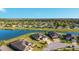 Scenic aerial showcasing lakeside homes with manicured lawns and views of the lake in a vibrant community at 6558 Sw 94Th Cir, Ocala, FL 34481