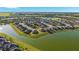 Aerial view of the community showcases homes situated along a scenic lake with lush surroundings at 6558 Sw 94Th Cir, Ocala, FL 34481
